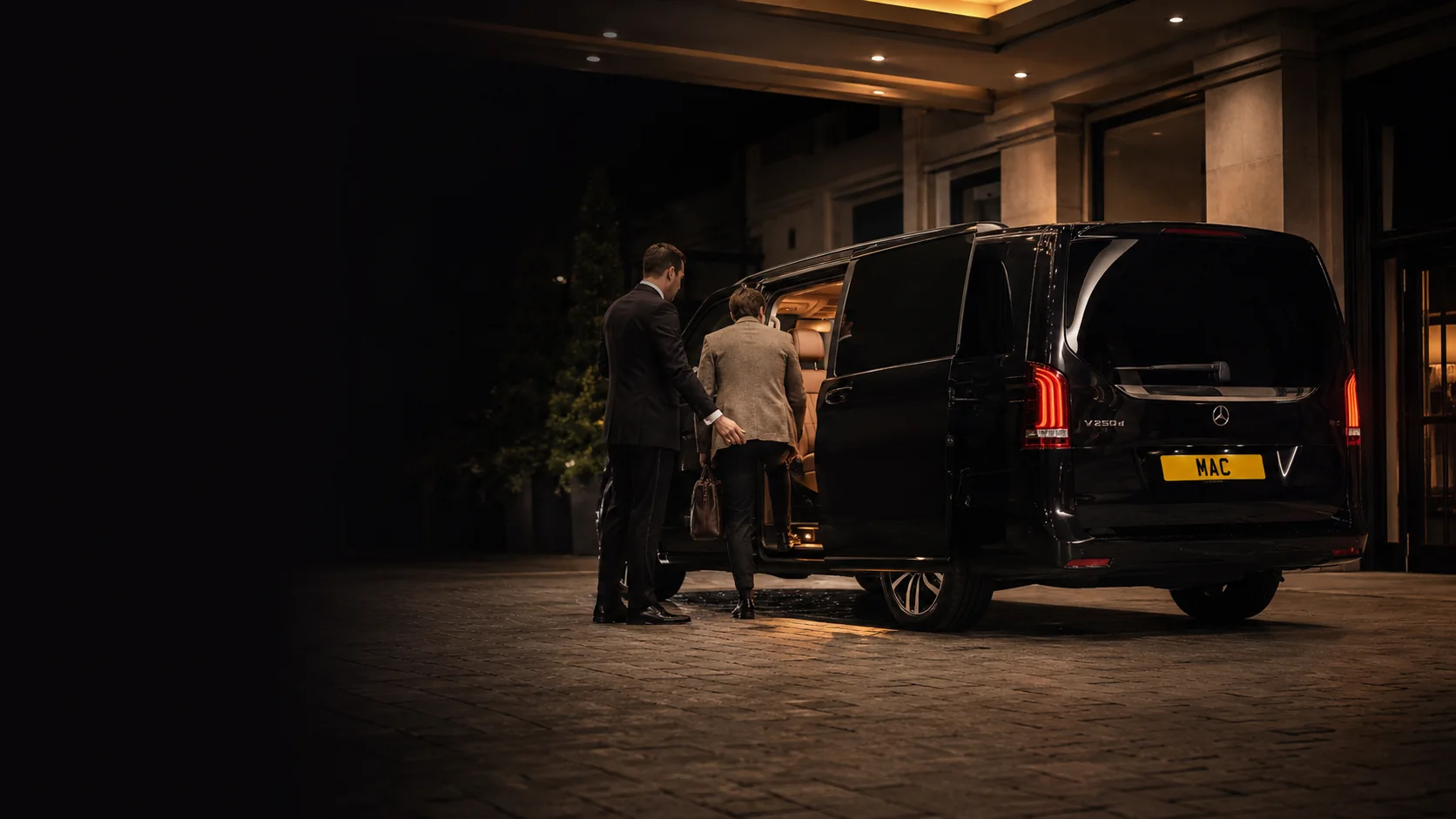 Private chauffeur vehicle arriving at a premium Liverpool city-centre hotel in the evening