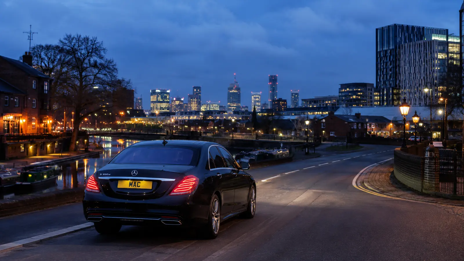 Black MAC Mercedes travelling through Birmingham at dusk