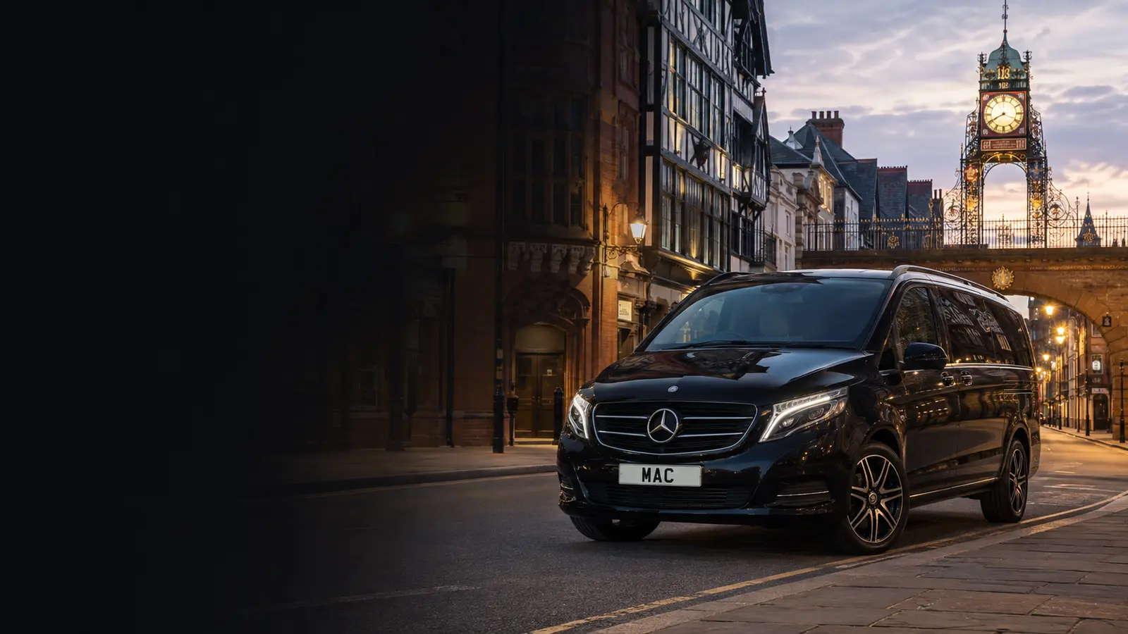 Black Mercedes V-Class in Chester near the Eastgate Clock for a Manchester Airport chauffeur journey