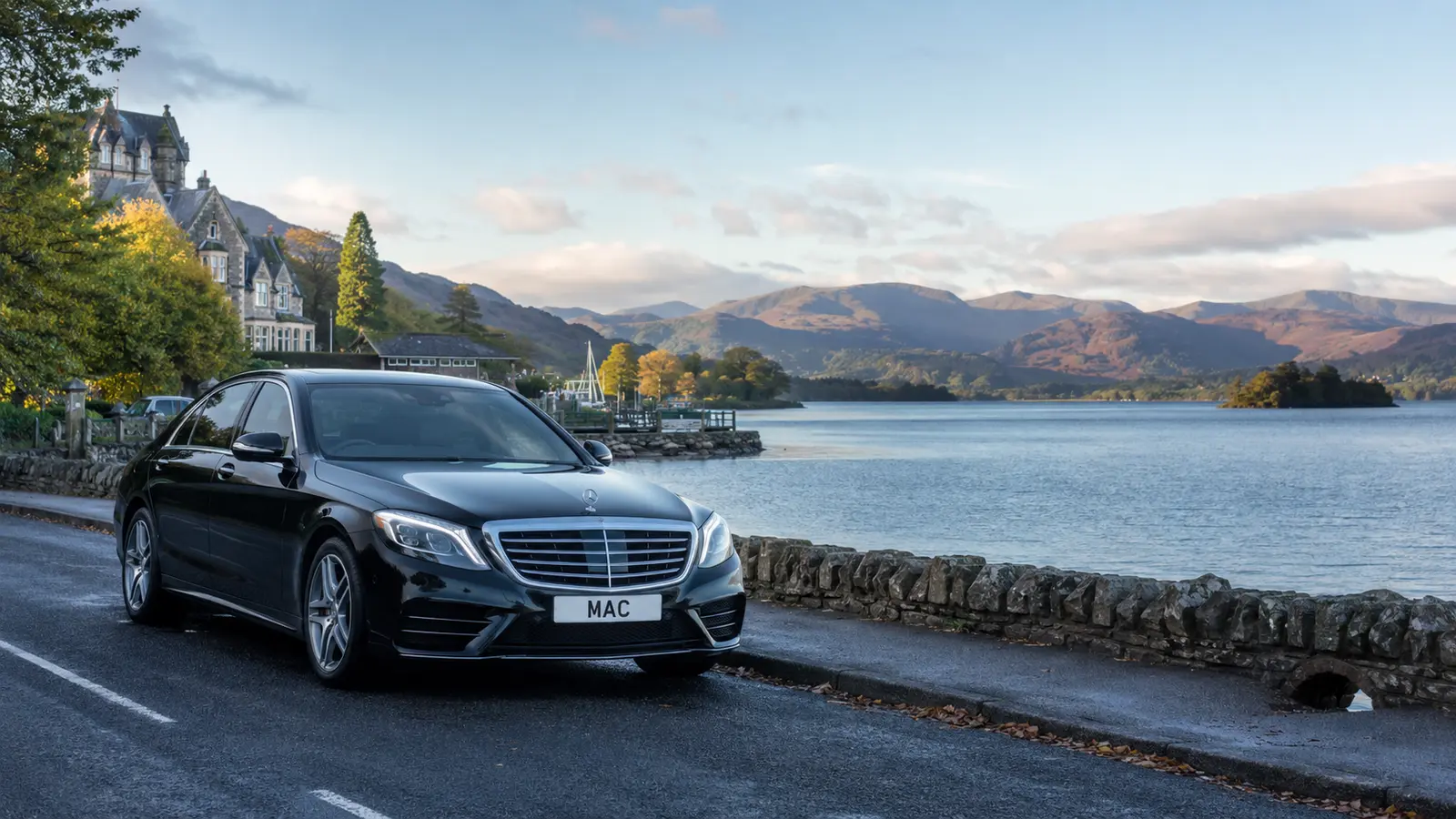 Black MAC Mercedes beside Windermere on a chauffeur journey from Manchester Airport