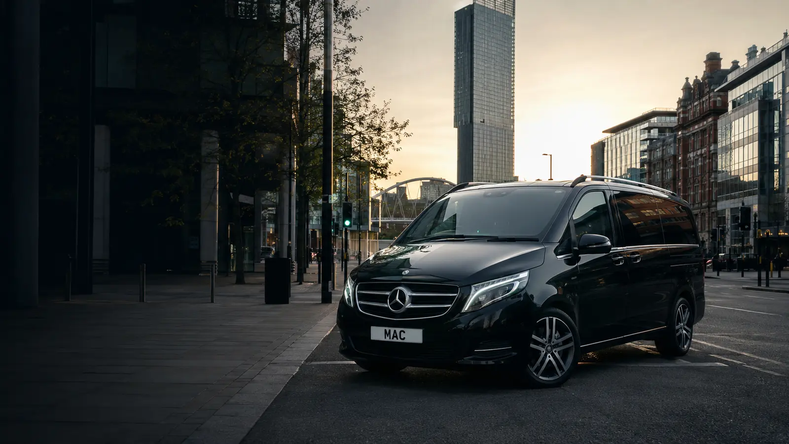Black MAC Mercedes chauffeur vehicle arriving in Manchester city centre