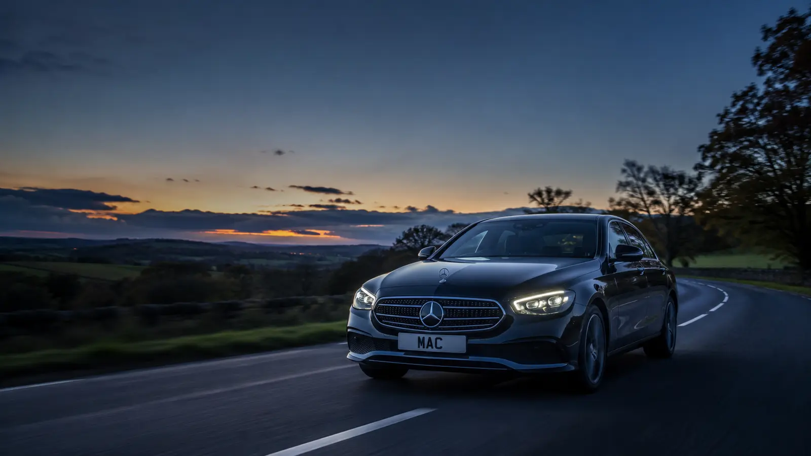 Black Mercedes E-Class travelling through the Cheshire countryside at dusk