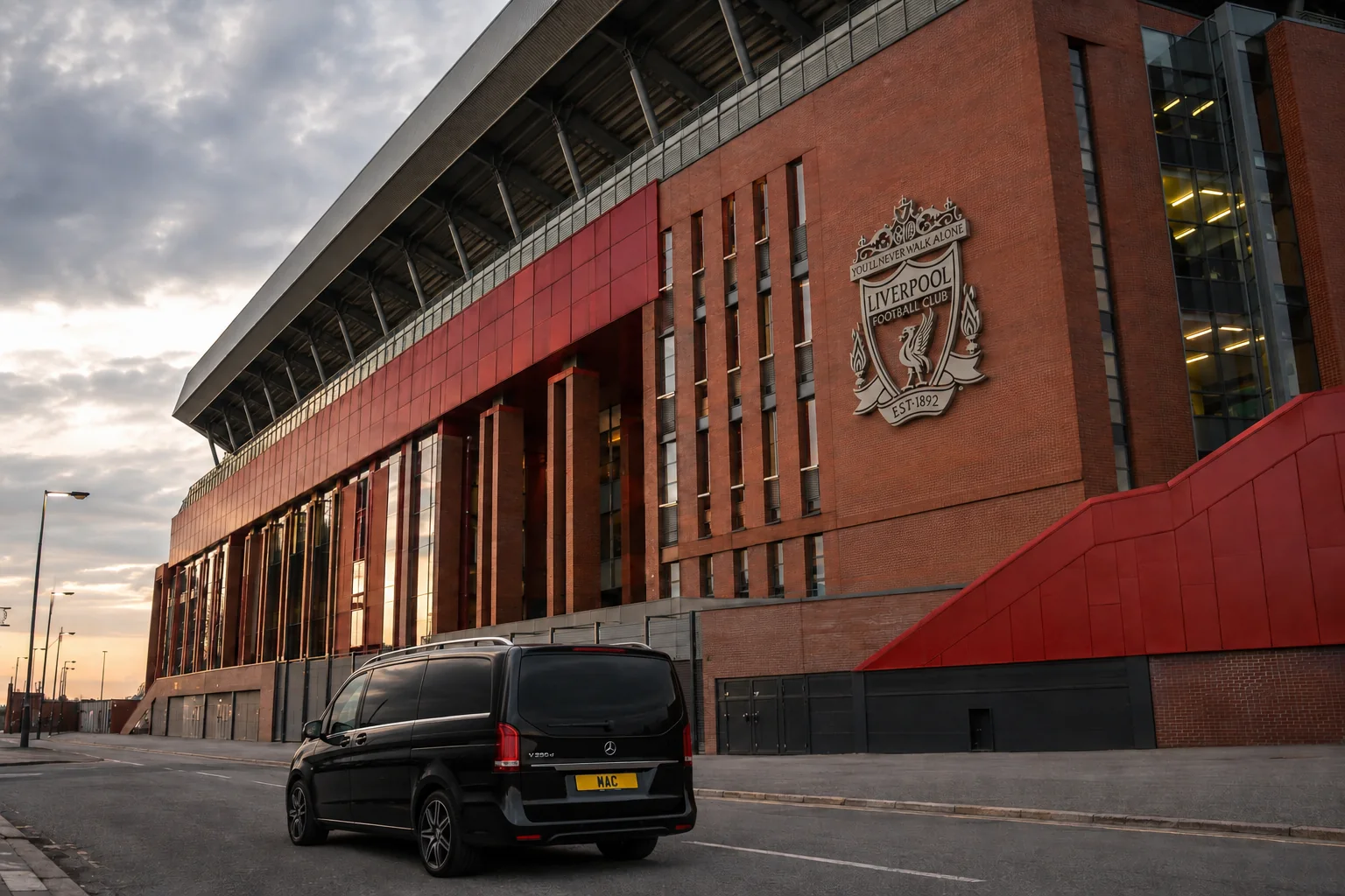 Black Mercedes V-Class chauffeur vehicle outside the Liverpool FC Main Stand at Anfield